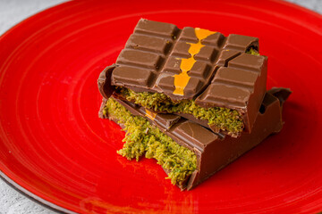 Dubai Chocolate bar with green kadayif and peanut butter on white stone table