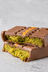 Dubai Chocolate bar with green kadayif and peanut butter on white stone table