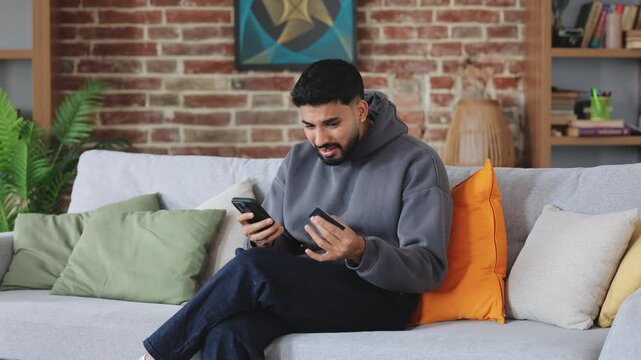 Confused man getting nervous while experiencing failure with using banking application in modern phone. Irritated consumer throwing away credit card while running out of budget during online shopping.