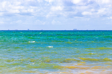 Tropical beach and water with waves in the Caribbean Mexico.