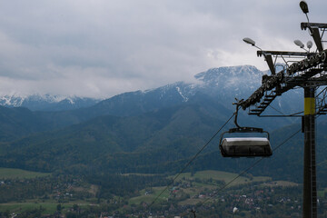 Ski Lift snowy mountain autumn forest with chair lift At The Ski Resort in Zakopane Poland....