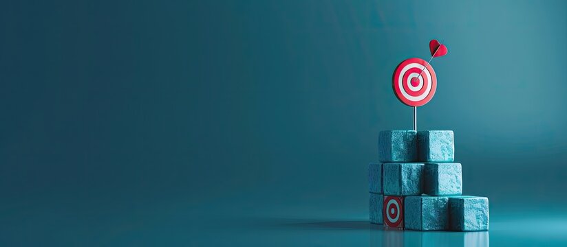 Aiming for progress through goal setting reaching new heights Symbols representing targets on stacked cubes against a blue backdrop with a copy space image