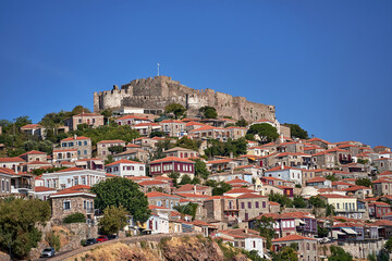 Fototapeta premium Historic houses and castle on top of a hill in Molyvos on the island of Lesbos, Greece