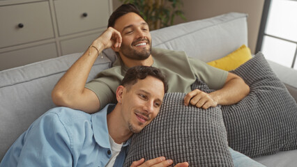 Gay couple relaxing on the couch at home, sharing a loving moment in the living room, illustrating a happy, intimate, and cozy family scene.