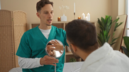 Therapist showing a reflection to a male patient in a serene spa room with candles and plants in the background
