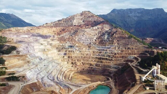 Aerial view of rugged mountain and expansive stone pit mine, Eisenerz, Styria, Austria.