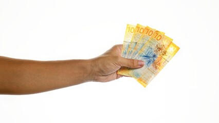 Hand holding swiss francs isolated on white background showing four 10 franc notes.