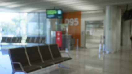 Defocused airport terminal with empty seating and gate d95 in the background, emphasizing the modern and spacious travel environment.