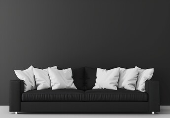 A black leather sofa with white pillows in front of a black wall