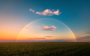 Rainbow over green field  sunset sky  hope and new beginnings  nature photography   