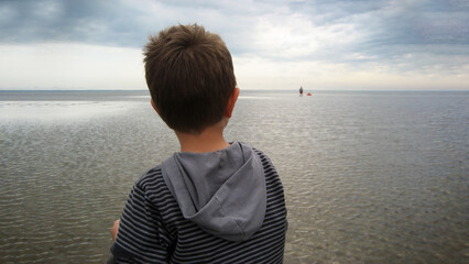 Fototapeta premium Boy looking at water