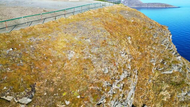 Aerial view of a dramatic cliff with a monument overlooking the sea, Nordkapp, Norway.