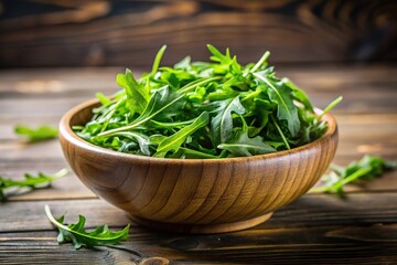 Fresh green salad arugula rucola in low angle bowl on wooden black or white background