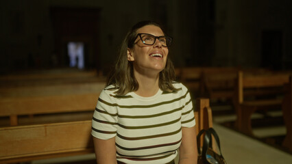 A young, beautiful hispanic woman in a church in italy, smiling with a look of joy and wonder in a...
