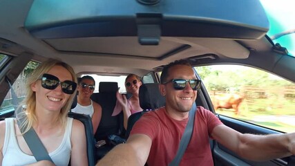 Friends enjoying road trip in car create lively atmosphere filled with laughter and excitement. Their carefree vacation highlights moments of bonding and adventure