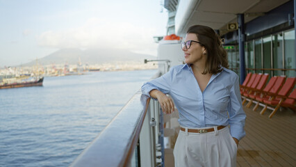 Woman enjoying scenic dock views on a cruise ship, showcasing a relaxed hispanic woman outdoors on a sunny day with an elegant demeanor facing the calm sea.