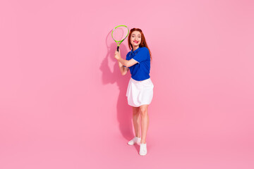 Full length photo of charming positive woman wear blue t-shirt enjoying squash empty space isolated pink color background