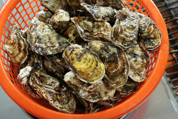 Korean seafood food. Fresh oysters in a basket