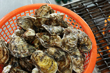 Korean seafood food. Fresh oysters in a basket