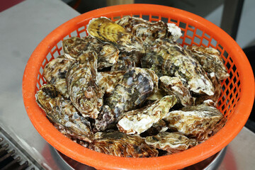 Korean seafood food. Fresh oysters in a basket