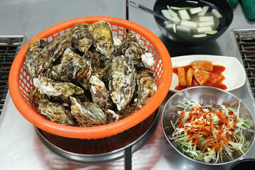 Korean seafood food. Fresh oysters in a basket