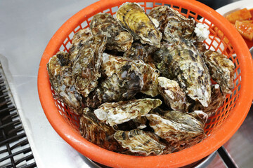 Korean seafood food. Fresh oysters in a basket