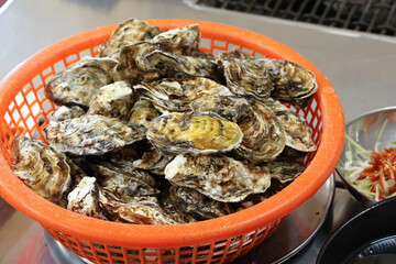 Korean seafood food. Fresh oysters in a basket