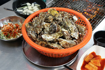 Korean seafood food. Fresh oysters in a basket