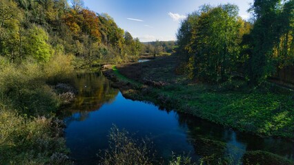 Serene river landscape with lush green trees.