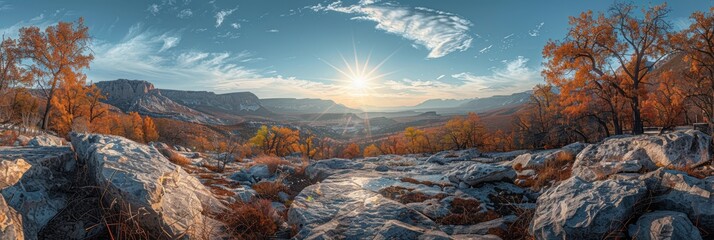 An awe-inspiring panoramic view of a rugged rocky landscape bathed in warm autumn sunlight, with towering mountains and an expansive, cloud-streaked sky in the distance