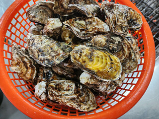 Korean seafood food. Fresh oysters in a basket