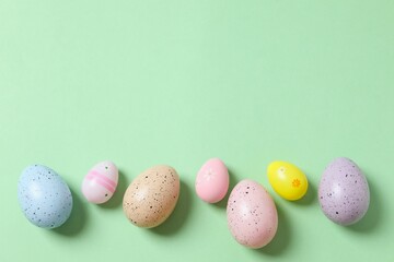 Happy Easter card. Easter eggs and decoration on color background, top view
