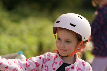 Little cute girl in helmet close up. Childhood fun concept