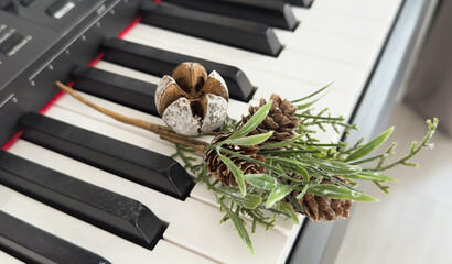 Piano keyboard with Christmas decoration, closeup