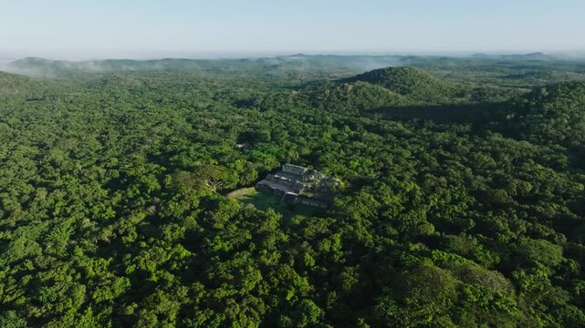 Aerial view of lush maya ruins and temple surrounded by dense forest, Sayil, Yucatan, Mexico.