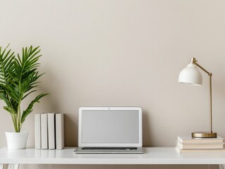 Obraz premium Stylish workspace featuring a laptop, lamp, books, and a plant, perfect for home office inspiration.