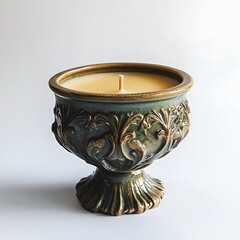 A scented candle in a decorative holder on a white background.