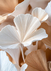 Close-up of ginkgo leaves, with light brown and white colors, layered paper art style