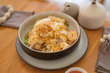 Appetizing Thai Stir-Fried Rice Noodles with Seafood (Kuay Tiew Kua Talay) - Delicious Traditional Dish with Shrimp, fish and squid.
