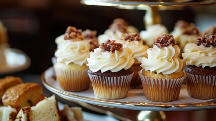 Delicious gourmet cupcakes served alongside a tray of sandwiches and scones