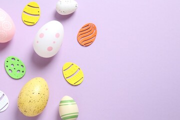 Happy Easter card. Easter eggs and decoration on color background, top view