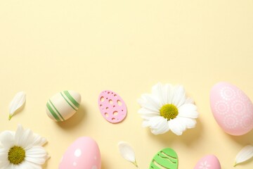 Easter eggs and decoration with flowers on color background, top view