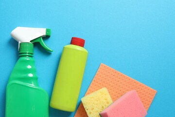 Many different house cleaning products on color background, top view