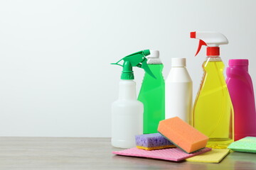 Many different house cleaning products on table