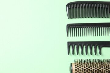 Professional combs and hairdresser tools on color background, top view