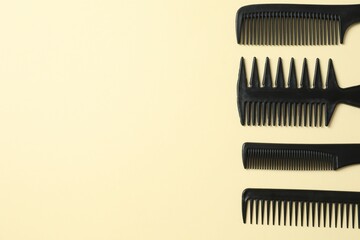 Professional combs and hairdresser tools on color background, top view