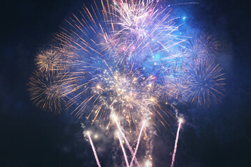 Amazing golden fireworks exploding in the starry night sky, concept. Holidays and New Year 2025,...