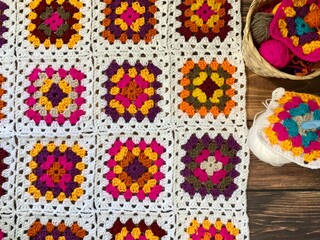 Granny square crocheted blanket with different colors motives, retro vintage craft handmade...
