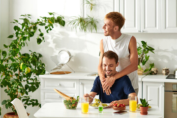 A happy couple enjoying each others company in a trendy kitchen.