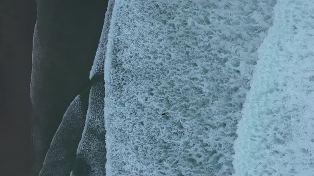 Drone shot of Foamy Sea Waves On The Beach In Caion, A Laracha, Spain